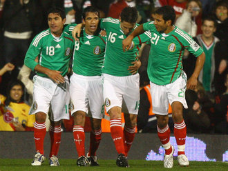 Mexico's players celebrate a goal against Ghana
